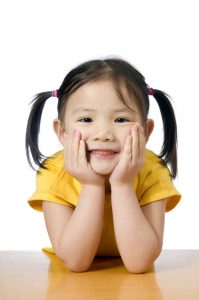 A young asian american girl smiling.