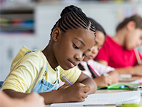 Girl working on test in classroom