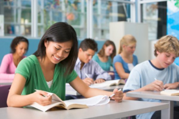 Teacher helping pupils study in the classroom