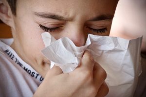 child blowing nose